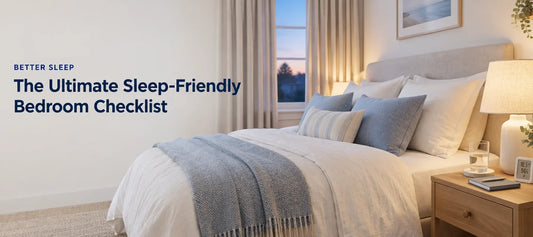 A calm, softly lit bedroom with light layered bedding, lined curtains, a bedside lamp and a glass of water, with the text The Ultimate Sleep-Friendly Bedroom Checklist