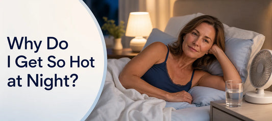 A woman lying in bed at night with the covers pushed back and a fan nearby, with the text Why Do I Get So Hot at Night?