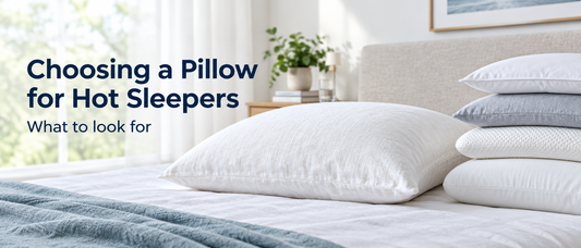 White cotton pillow with a linen pillowcase beside a stack of other pillows, with the text Choosing a Pillow for Hot Sleepers